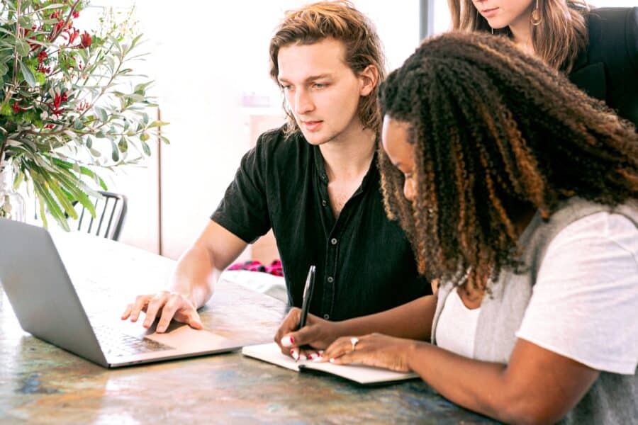 Two colleagues reviewing documents at a desk — illustrative of the office leasing process.