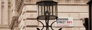 Street view of corner wall and iron gateway to Downing Street, London